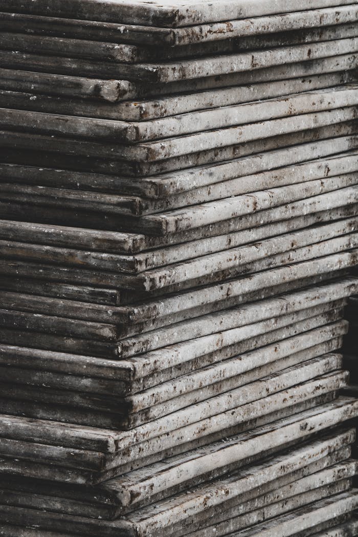 A vertical stack of rough, weathered concrete slabs showcasing an industrial texture.